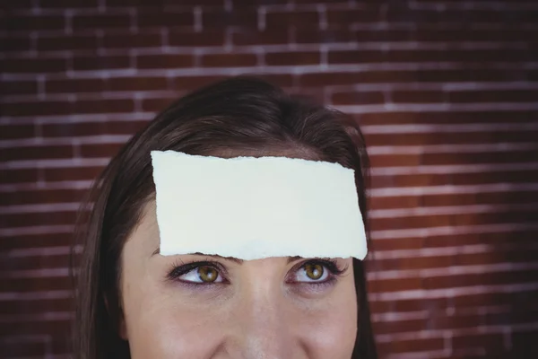 Pretty brunette with paper on head
