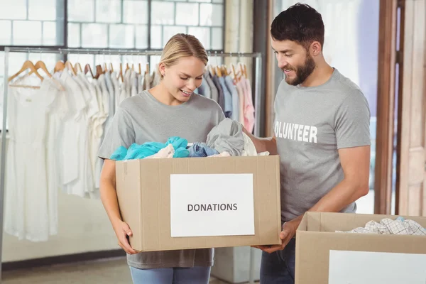 Man and woman volunteers with box