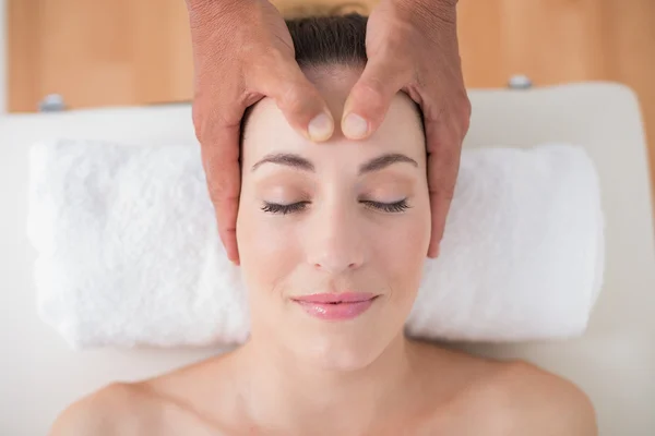 Woman receiving head massage