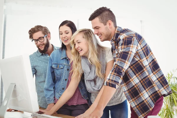 Happy business people working at computer desk