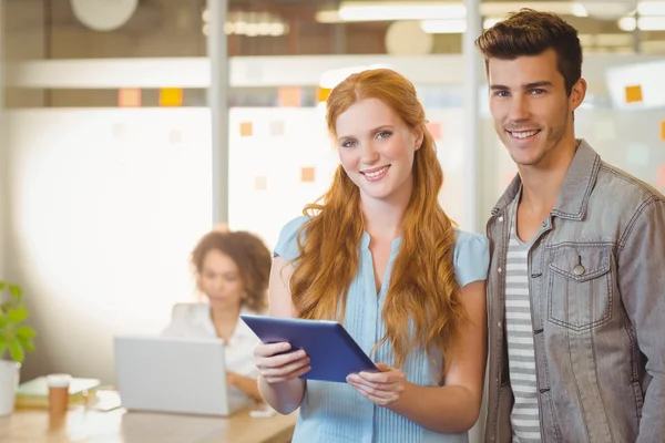 Portrait of business people holding digital PC