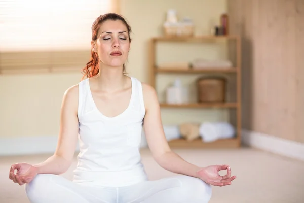Calm woman in yoga pose with eyes closed