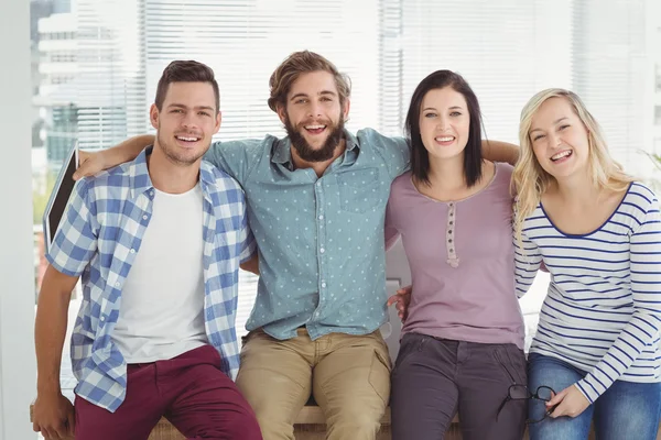 Portrait of happy business people with arm around