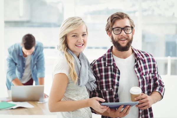 Man and woman working on digital tablet