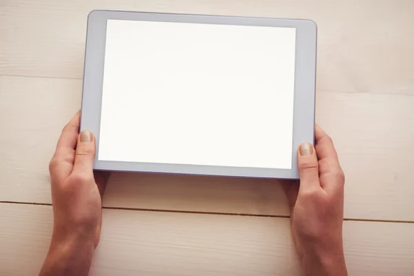 Hands holding blank screen tablet