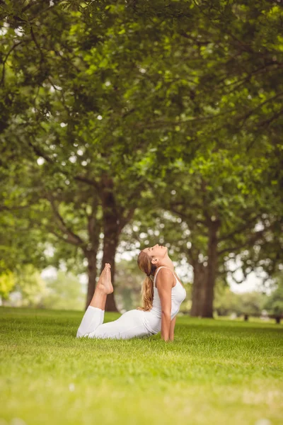 Full length woman stretching her body with legs raised