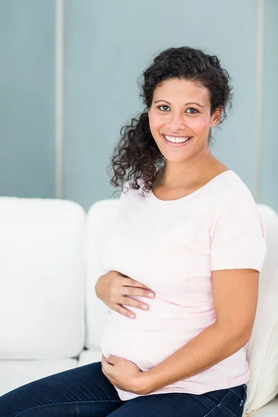 Portrait of happy woman against wall