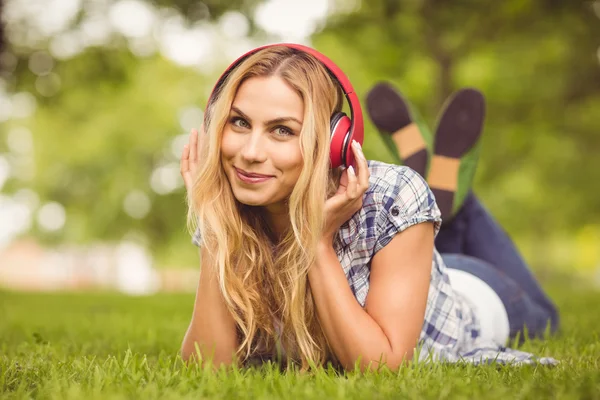 Full length portrait of cheerful woman listening to music