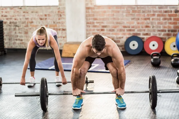 Two fit people working out at crossfit session