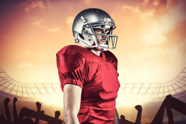 Composite image of serious american football player in red jerse