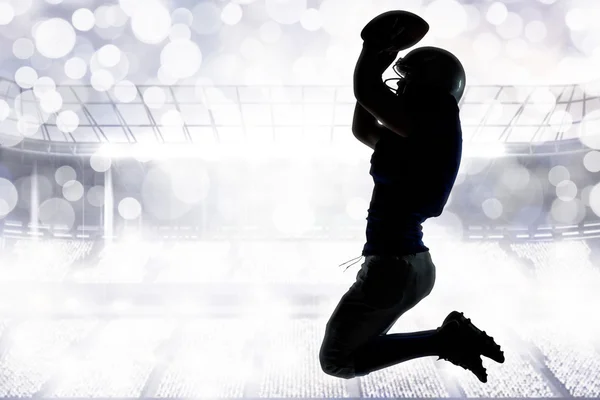 Silhouette of American football player jumping