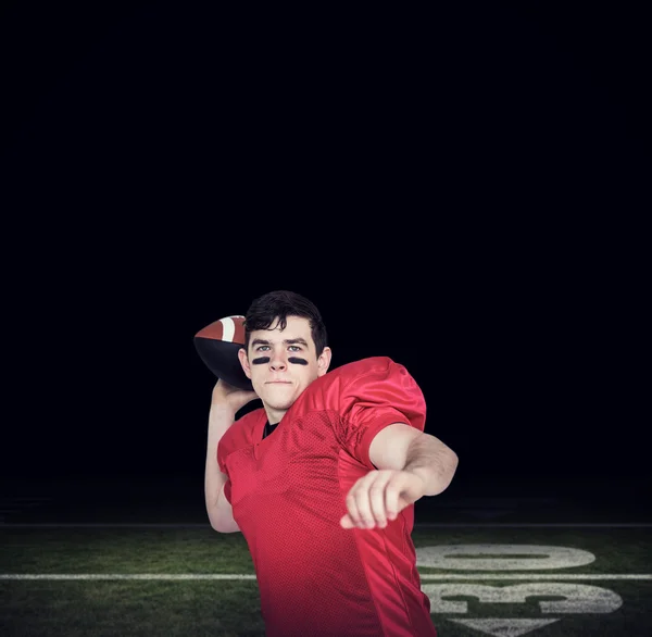 American football player throwing a ball