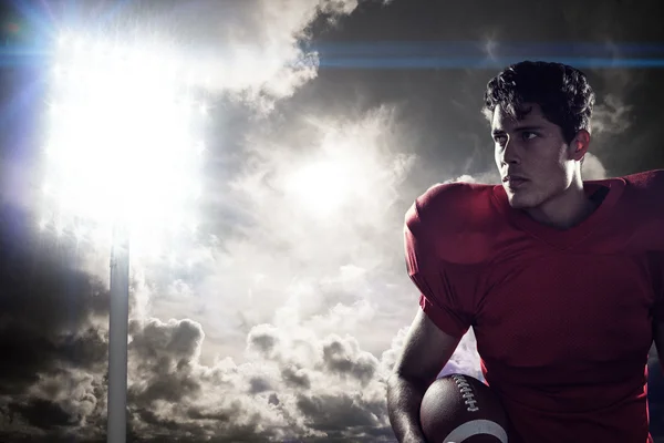 Serious American football player looking away