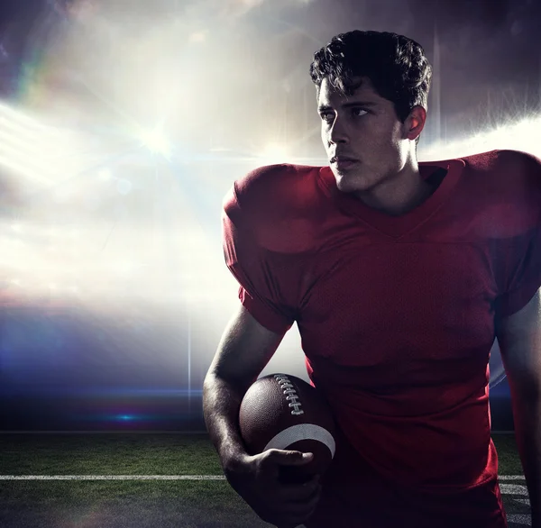 Serious American football player looking away