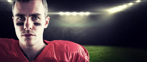 Serious american football player looking at camera