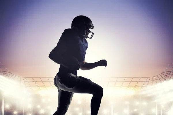 Silhouette of american football player runing
