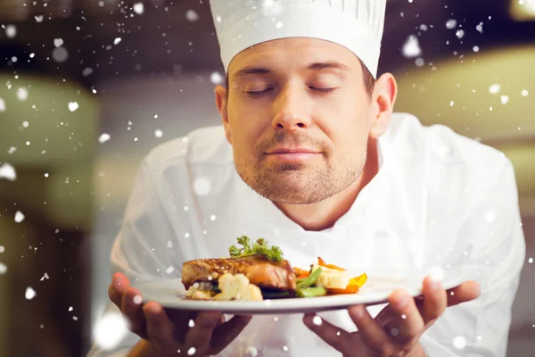 Chef with eyes closed smelling food