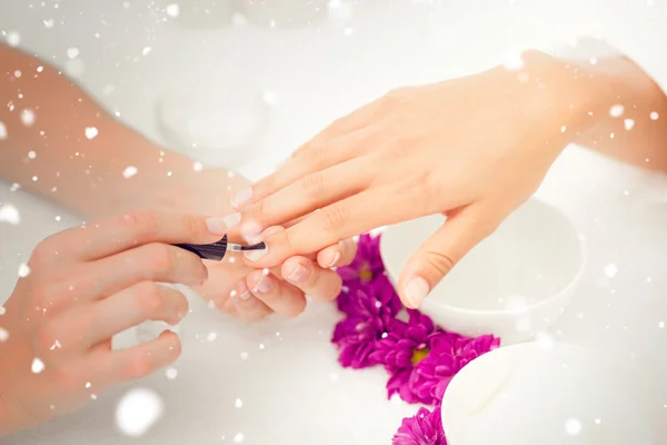 Woman applying nail varnish