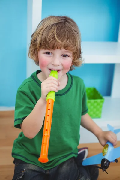 Small boy playing the flute