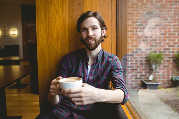 Hipster student having coffee in canteen