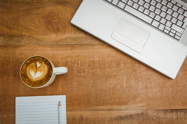 Laptop and a coffee on wood desk