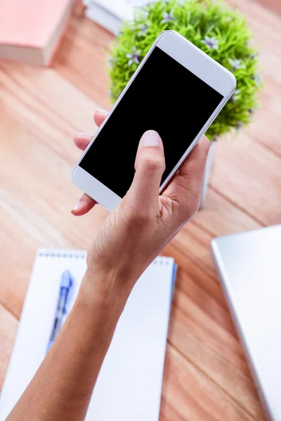 Overhead of feminine hand using smartphone