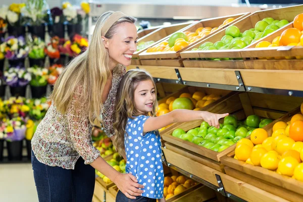 Mother and daughter in grocery shop