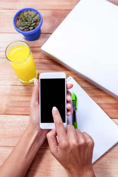 Overhead of feminine hands using smartphone