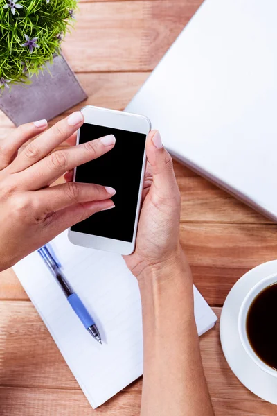 Overhead of feminine hands using smartphone