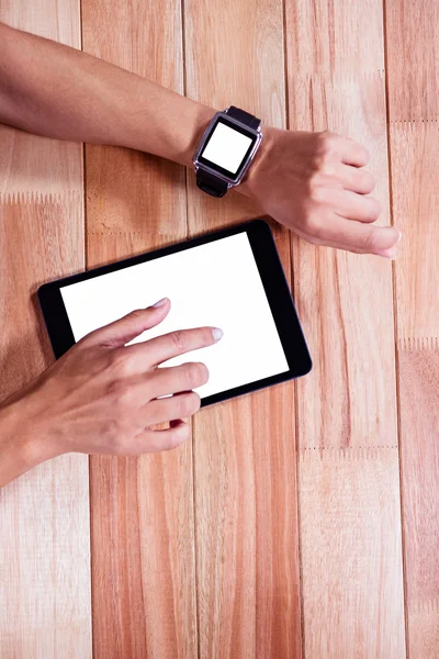 Feminine hands with smartwatch using tablet