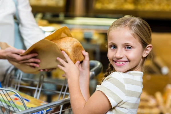 Daughter taking bread from paper bag