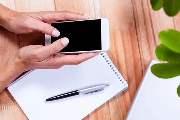 Overhead of feminine hands using smartphone