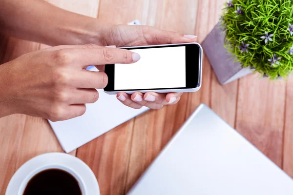 Overhead of feminine hands using smartphone