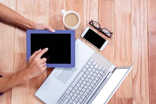 Overhead of feminine hands using tablet