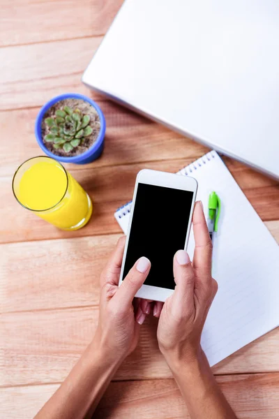 Overhead of feminine hands using smartphone