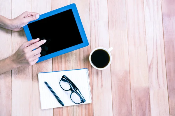 Overhead of feminine hands using tablet