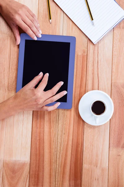 Overhead of feminine hands using tablet