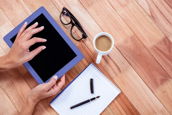 Overhead of feminine hands using tablet