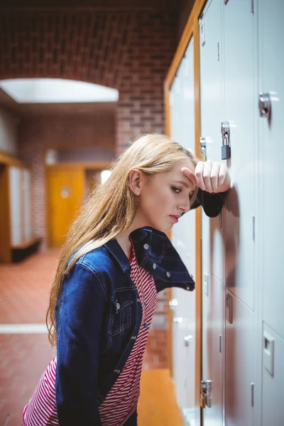 Worried leaning against the locker