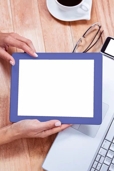 Overhead of feminine hands holding tablet