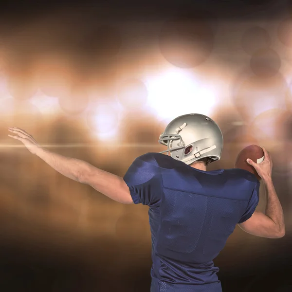 American football player throwing ball