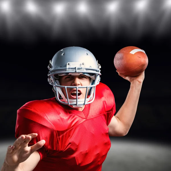 American football player throwing ball