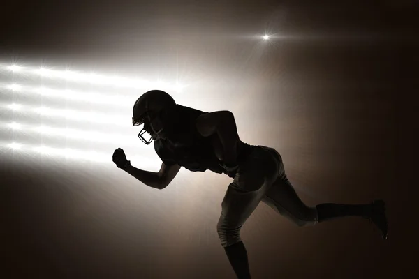 Silhouette of american football player running