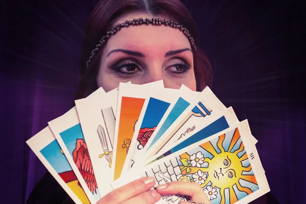 Fortune teller holding tarot cards