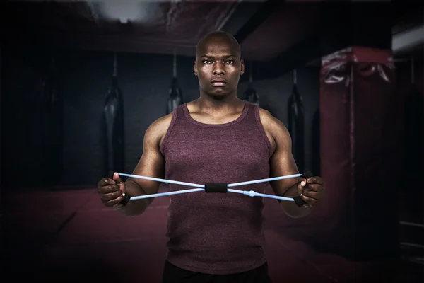 Fit man exercising with resistance band