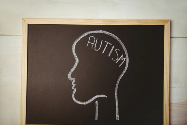 Autism drawn on blackboard with head