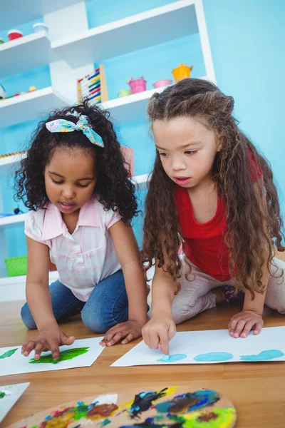 Cute girls painting with their fingers