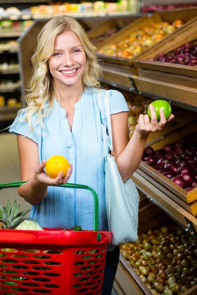 Smiling woman with shopping basket