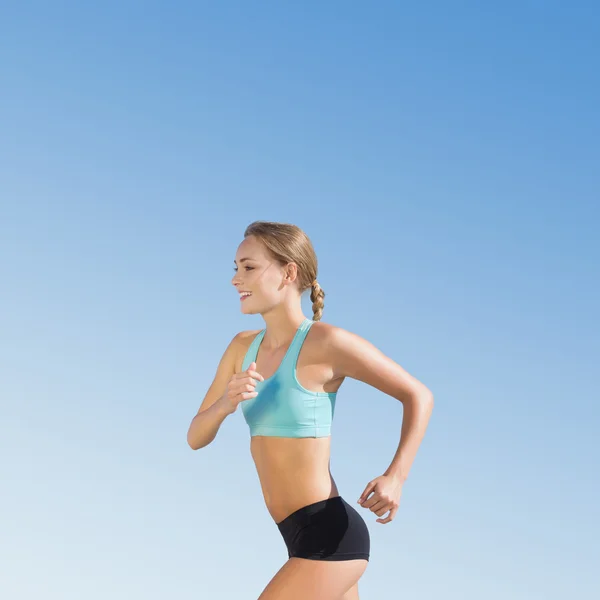 Composite image of fit woman jogging