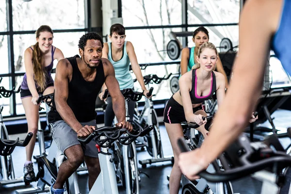 Fit people working out at spinning class